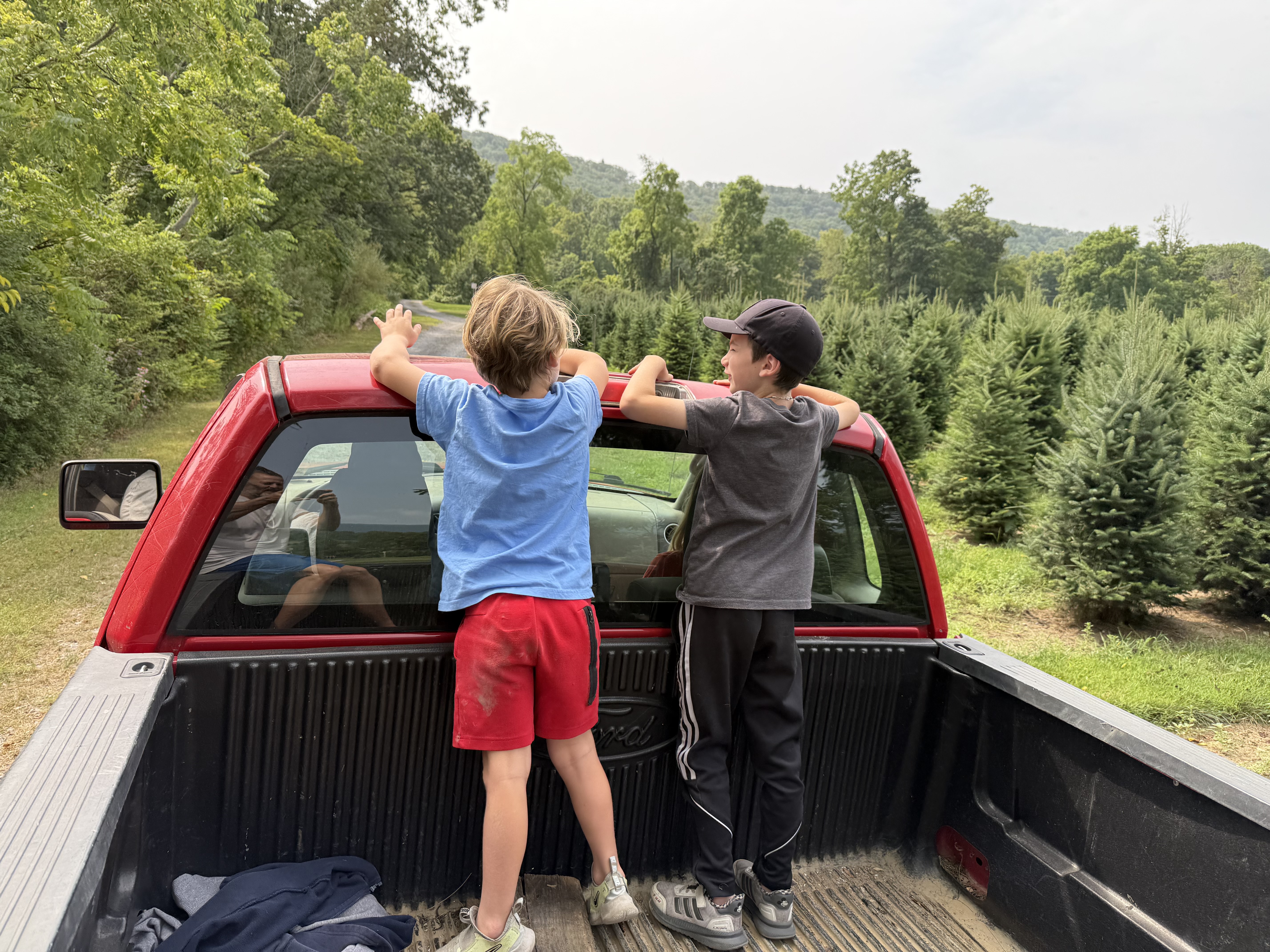 John's grandsons enjoying a ride in the farm truck